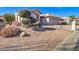 Charming single-story home with desert landscaping, a two-car garage, and a welcoming entrance at 9437 E Champagne Dr, Sun Lakes, AZ 85248