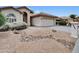 Desert landscaping featuring gravel and decorative rock elements around a cozy home at 9437 E Champagne Dr, Sun Lakes, AZ 85248