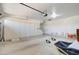 Large garage with built-in storage cabinets and overhead door at 9437 E Champagne Dr, Sun Lakes, AZ 85248