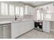 Modern kitchen showcasing stainless steel appliances, marble counter tops, and crisp white cabinets at 9437 E Champagne Dr, Sun Lakes, AZ 85248