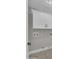 A laundry room with storage cabinets and appliances, showcasing the space's organization and functionality at 9437 E Champagne Dr, Sun Lakes, AZ 85248