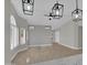 Spacious living room featuring sleek flooring and contemporary light fixtures at 9437 E Champagne Dr, Sun Lakes, AZ 85248