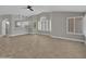 Open concept living room featuring wood flooring, modern lighting, and bright windows with window coverings at 9437 E Champagne Dr, Sun Lakes, AZ 85248