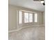 Sunlit living room features shuttered windows and wood-look tile flooring with clean, modern lines at 9437 E Champagne Dr, Sun Lakes, AZ 85248