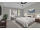 This main bedroom features neutral walls, a ceiling fan, and a bay window with plantation shutters at 9437 E Champagne Dr, Sun Lakes, AZ 85248