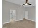 Main bedroom boasts neutral walls, wood floors, ceiling fan, and entry to the ensuite bathroom at 9437 E Champagne Dr, Sun Lakes, AZ 85248