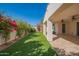 Expansive backyard featuring lush landscaping, a covered patio, and a charming swing set for outdoor enjoyment at 9729 E Theia Dr, Mesa, AZ 85212