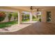 Covered patio with stone flooring, ceiling fans, and a view of the landscaped backyard at 9729 E Theia Dr, Mesa, AZ 85212