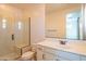 Bright bathroom featuring single sink vanity, glass shower stall, and white cabinets at 9729 E Theia Dr, Mesa, AZ 85212