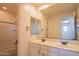 Well-lit bathroom with a double sink vanity, large mirror, and combined shower and tub at 9729 E Theia Dr, Mesa, AZ 85212