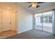 Bedroom with large sliding glass door to patio, carpet and ceiling fan at 9729 E Theia Dr, Mesa, AZ 85212