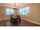 Well lit dining room with hardwood floors, large windows and ample seating at 9729 E Theia Dr, Mesa, AZ 85212