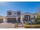 Charming two-story home featuring a well-maintained front yard, brick driveway and neutral colored stucco at 9729 E Theia Dr, Mesa, AZ 85212