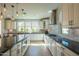 Modern kitchen featuring white cabinets, stainless steel appliances, and stone countertops at 9729 E Theia Dr, Mesa, AZ 85212