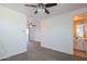 Spacious room with neutral carpet and view into another room with vanity sink at 9729 E Theia Dr, Mesa, AZ 85212