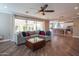 Spacious living room featuring hardwood floors, fan, recessed lights, and an open floor plan at 9729 E Theia Dr, Mesa, AZ 85212