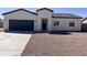 Beautiful home with a dark gray two car garage, desert landscape and a covered entry at 10771 W Arvada Dr, Arizona City, AZ 85123