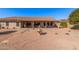 Wide backyard featuring desert landscaping, a stone fountain, and a covered patio at 11525 E Laguna Azul Cir, Mesa, AZ 85209