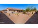 Backyard featuring desert landscaping, a covered patio, and solar panels at 11525 E Laguna Azul Cir, Mesa, AZ 85209