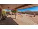 Charming covered patio and backyard featuring a stone fountain and manicured desert landscaping at 11525 E Laguna Azul Cir, Mesa, AZ 85209