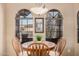 Charming breakfast nook featuring arched windows that provide ample natural light and a view of the outdoors at 11525 E Laguna Azul Cir, Mesa, AZ 85209