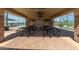 Outdoor community area under shelter with picnic tables and views of the tennis and pickleball courts at 11525 E Laguna Azul Cir, Mesa, AZ 85209