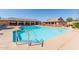 Inviting community pool with lounge chairs, covered seating areas and pristine water at 11525 E Laguna Azul Cir, Mesa, AZ 85209