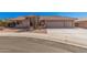 Charming single-story home featuring a three-car garage, tile roof, and desert landscaping at 11525 E Laguna Azul Cir, Mesa, AZ 85209