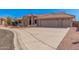 Charming single-story home featuring a three-car garage, tile roof, and desert landscaping at 11525 E Laguna Azul Cir, Mesa, AZ 85209