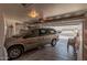Spacious garage with ample storage and a tan minivan parked inside at 11525 E Laguna Azul Cir, Mesa, AZ 85209