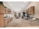 Spacious kitchen featuring granite countertops, wood cabinets, modern appliances, and an adjacent breakfast area at 11525 E Laguna Azul Cir, Mesa, AZ 85209