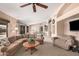 Spacious living room with comfortable seating, ceiling fan and views to other spaces at 11525 E Laguna Azul Cir, Mesa, AZ 85209