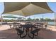 Covered picnic area with metal tables and benches, providing shade for community gatherings at 11525 E Laguna Azul Cir, Mesa, AZ 85209