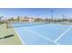 Brightly colored tennis courts located in a residential neighborhood at 11525 E Laguna Azul Cir, Mesa, AZ 85209