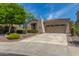 Inviting single-story home with a desert landscaped front yard and attached two car garage at 12098 W Lone Tree Trl, Peoria, AZ 85383