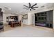 Bright living area with tile floors, a modern ceiling fan, and a decorative electric fireplace at 12098 W Lone Tree Trl, Peoria, AZ 85383