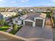 Stunning aerial view of a single-story home with a three-car garage and a tile roof in a planned community at 12539 W Tuckey Ln, Glendale, AZ 85307