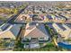 Overhead shot of a home, displaying the rear yard, pool, and the surrounding neighborhood in a Primary-planned community at 12539 W Tuckey Ln, Glendale, AZ 85307