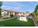 Beautifully landscaped yard with lush artificial turf, featuring an outdoor sink and faucet at 12539 W Tuckey Ln, Glendale, AZ 85307