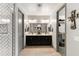 Bright bathroom showcasing dual vanities and a tile shower at 12539 W Tuckey Ln, Glendale, AZ 85307