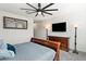 Cozy bedroom features a ceiling fan, mounted TV, dresser, and lamps for a relaxing atmosphere at 12539 W Tuckey Ln, Glendale, AZ 85307