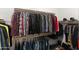 Walk-in closet with organized storage and a variety of hanging clothes, designed for maximum space efficiency at 12539 W Tuckey Ln, Glendale, AZ 85307