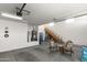 Well-lit garage includes stairs, storage, and plenty of room for parking and projects at 12539 W Tuckey Ln, Glendale, AZ 85307