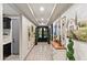 Elegant hallway with decorative wall art, mirrors, and views of the front entry at 12539 W Tuckey Ln, Glendale, AZ 85307