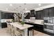 Well-equipped kitchen boasting stainless steel appliances, a large island, and sleek dark cabinetry at 12539 W Tuckey Ln, Glendale, AZ 85307