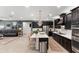 Stylish kitchen area featuring modern dark cabinetry, white countertops, and pendant lighting at 12539 W Tuckey Ln, Glendale, AZ 85307