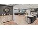Open-concept living room and kitchen area with dark gray walls, white trim, and tiled floors at 12539 W Tuckey Ln, Glendale, AZ 85307
