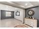 Open-concept living room with hardwood floors, modern light fixture, gray accent wall, and stylish decorations at 12539 W Tuckey Ln, Glendale, AZ 85307