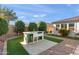 Backyard with outdoor kitchen and beautiful artificial grass at 12539 W Tuckey Ln, Glendale, AZ 85307