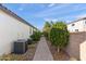 A side yard with two AC units, brick path and lovely landscaping at 12539 W Tuckey Ln, Glendale, AZ 85307